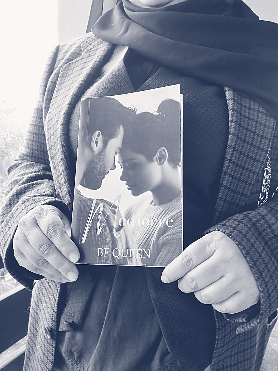 Fatima holding her novel Mediocre