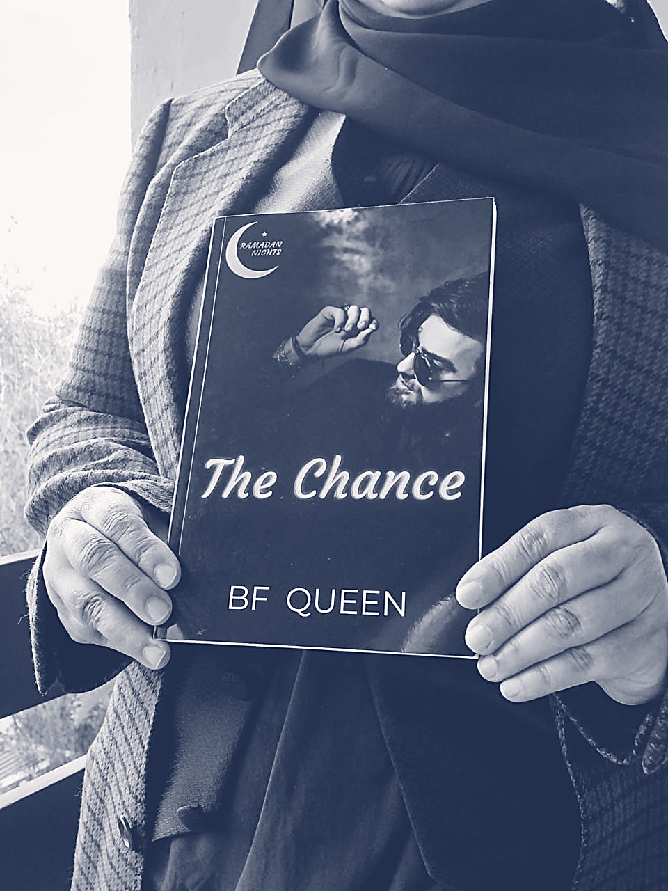 Fatima holding her novel The Chance